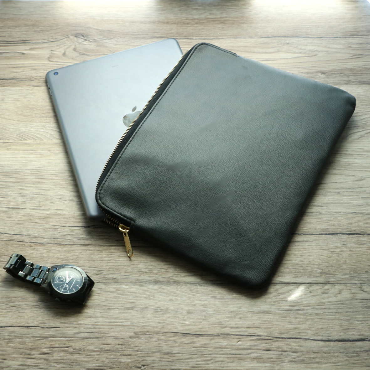 Front view of black leather tablet sleeve with zipper for men