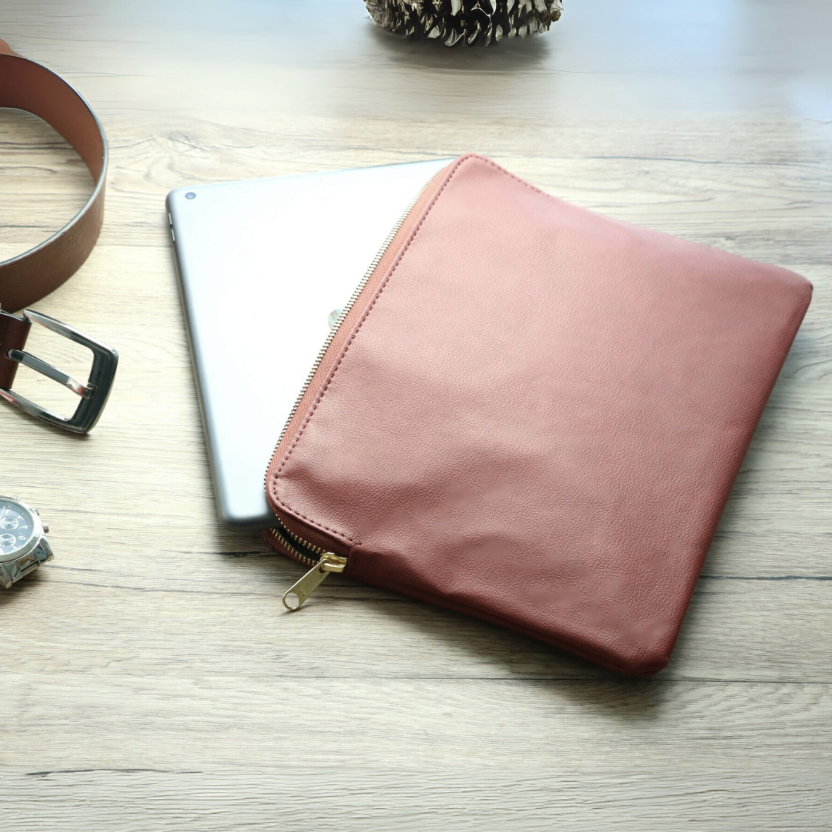 iPad being inserted into brown leather case for work or travel