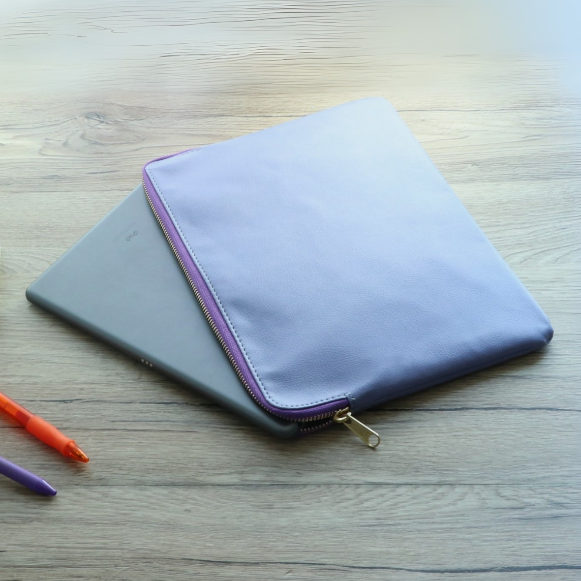 iPad being inserted into lavender leather sleeve for work or on-the-go