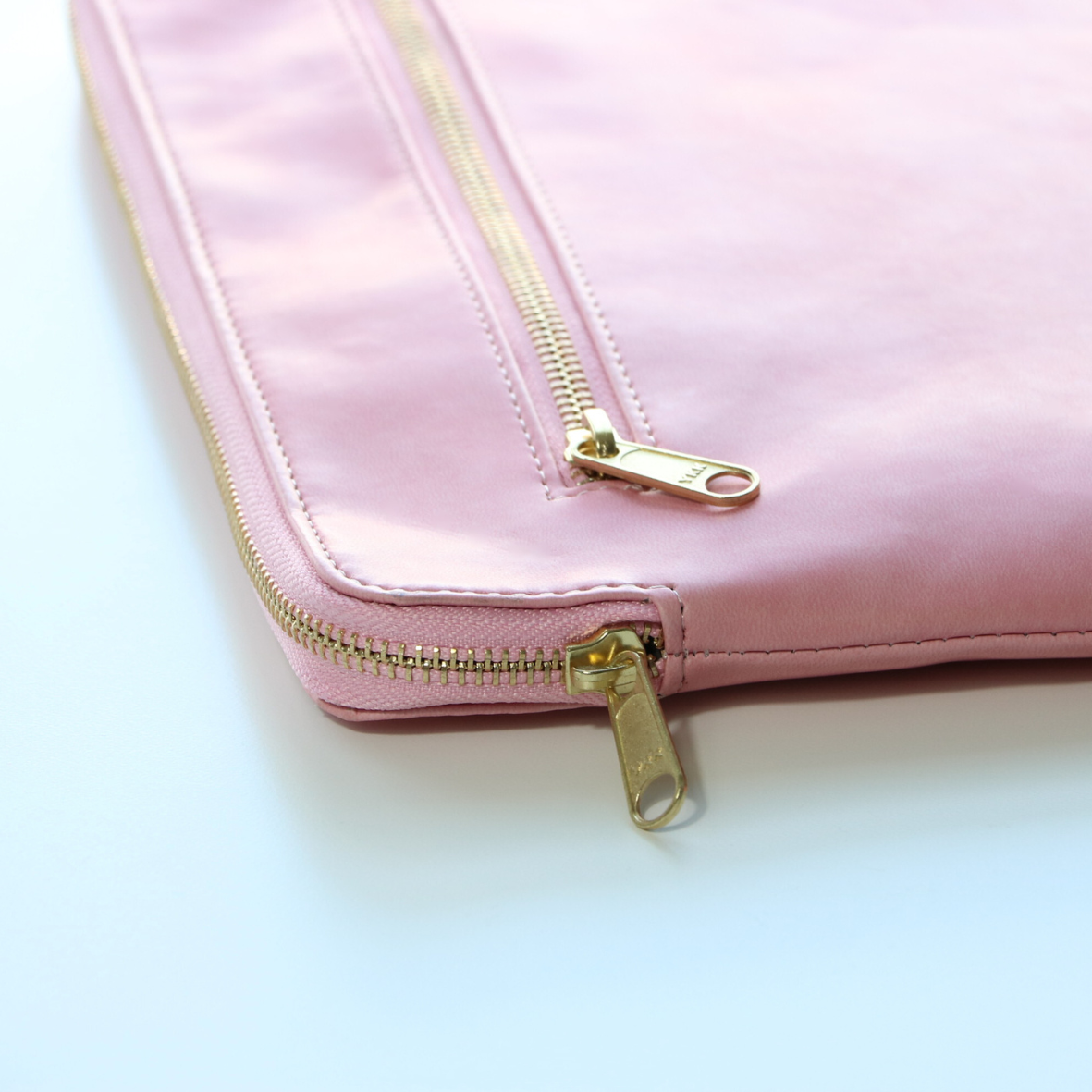 Close-up of high-quality zipper on pink leather tablet case