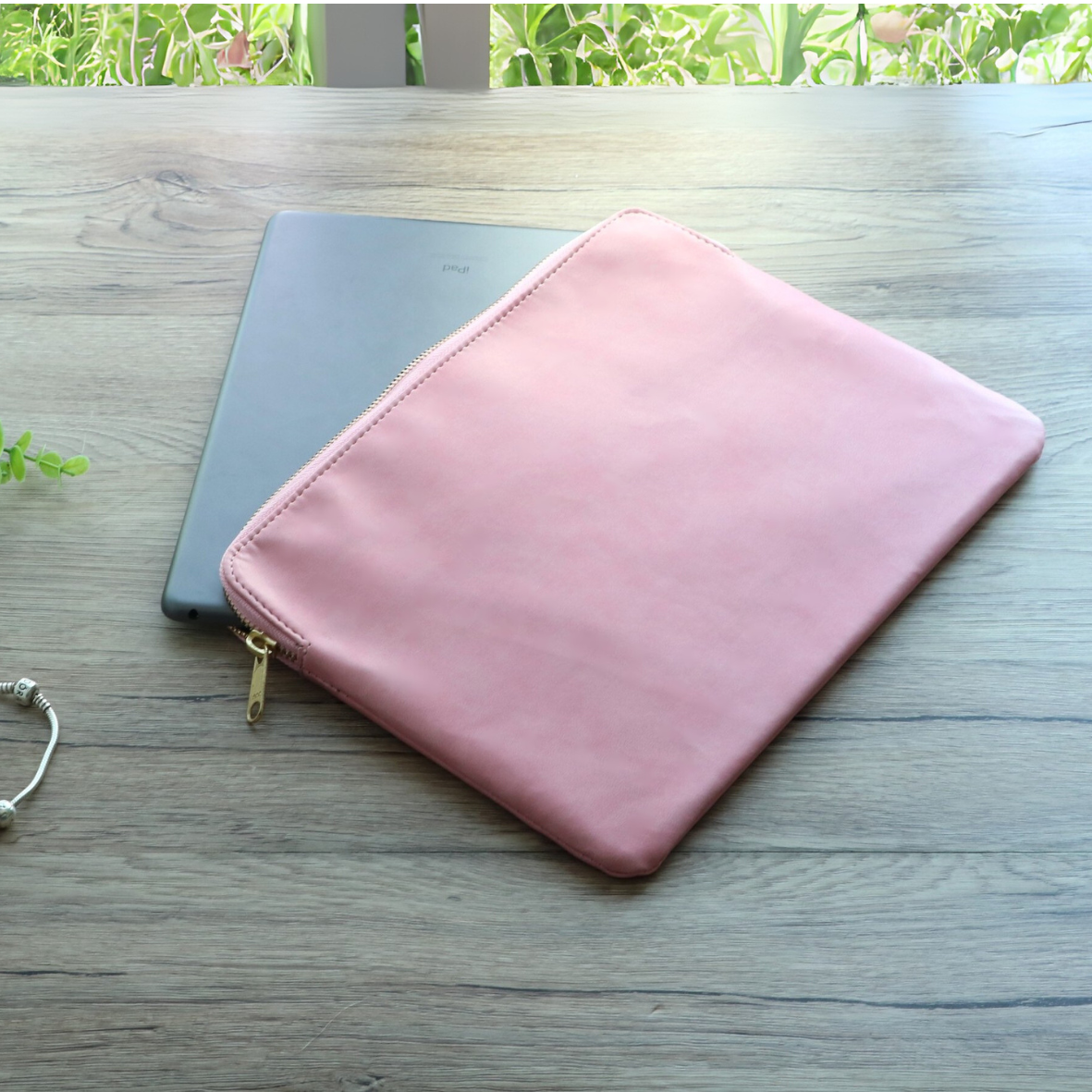 iPad being inserted into pink leather sleeve for work or on-the-go