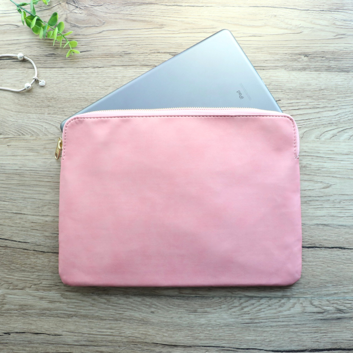 Front view of pink leather tablet sleeve with zipper for women