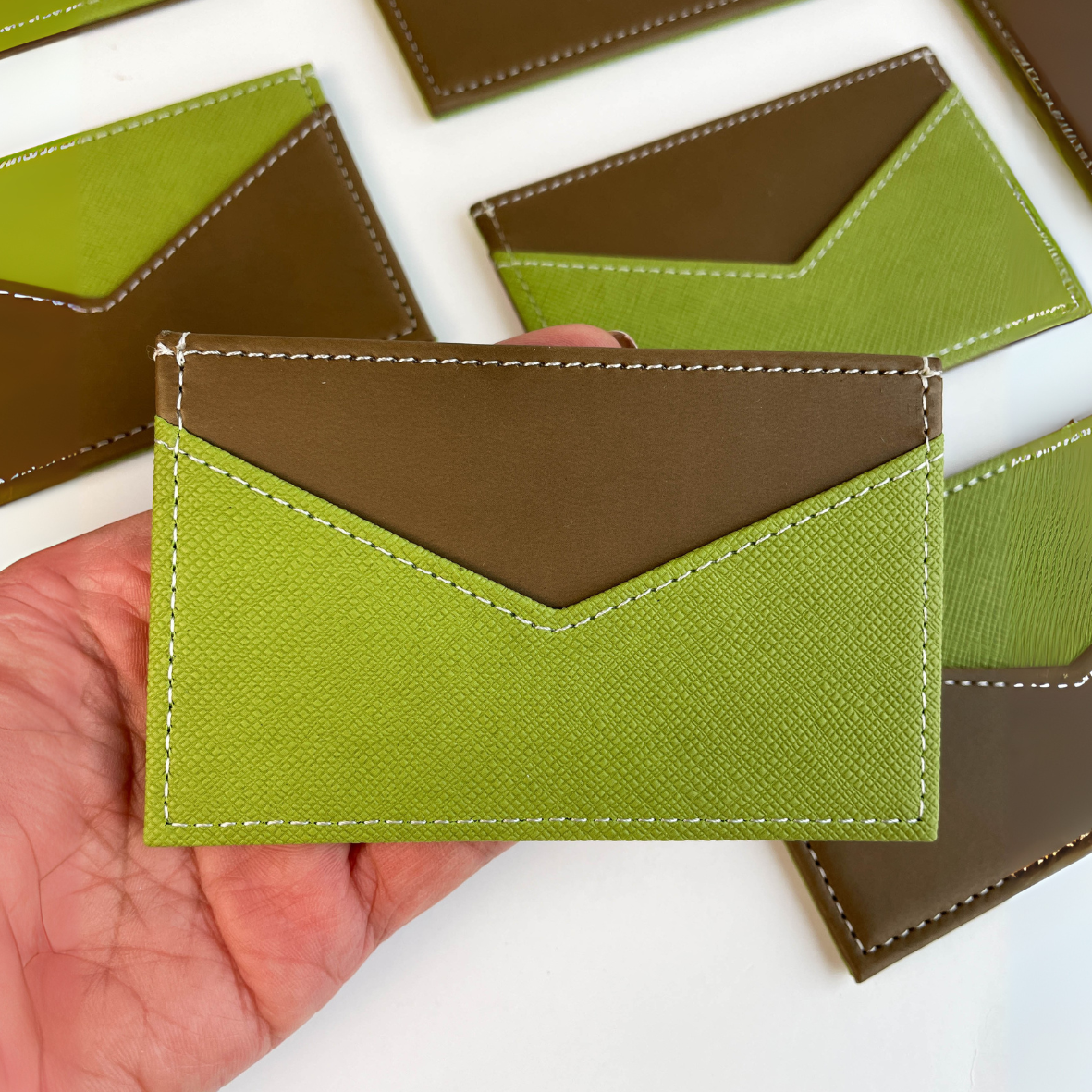 Slim profile of green leather RFID card holder, perfect for pockets and travel
